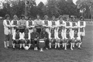The Ajax squad who won the 1971/72 European Cup, pictured with the trophy